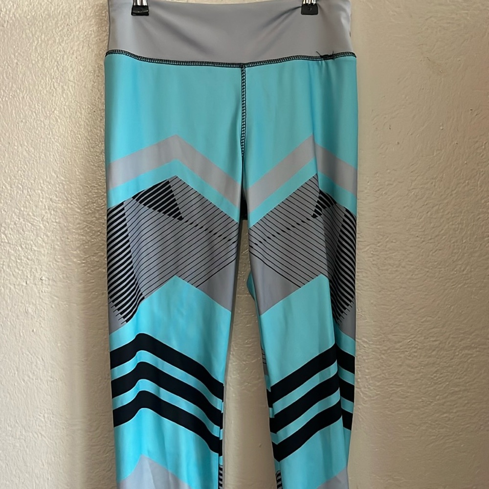 Grey and teal leggings with a geometric chevron pattern